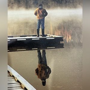 Man standing on Dock reflection shot.